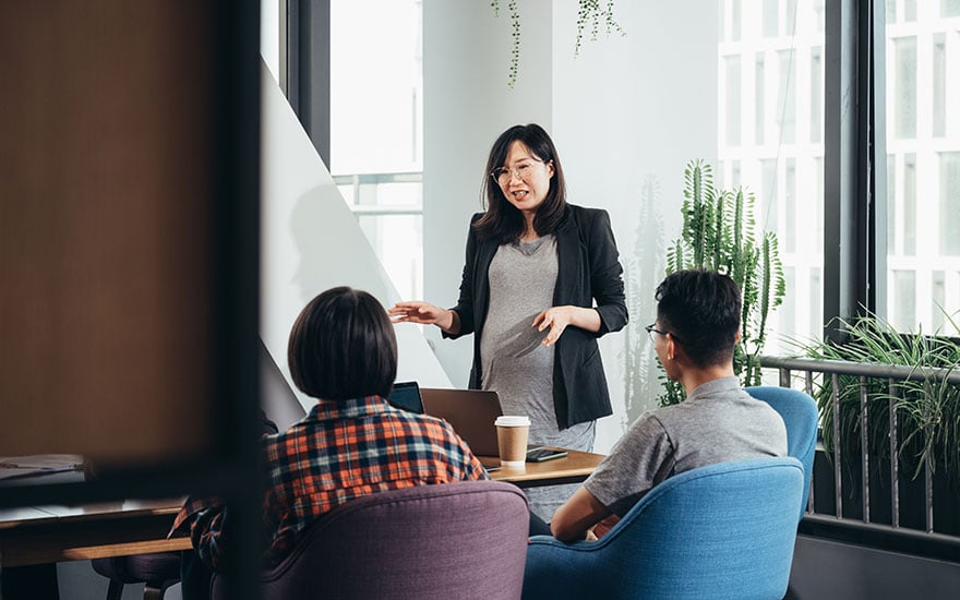 Professional-woman-doing-a-presentation-to-her-employees