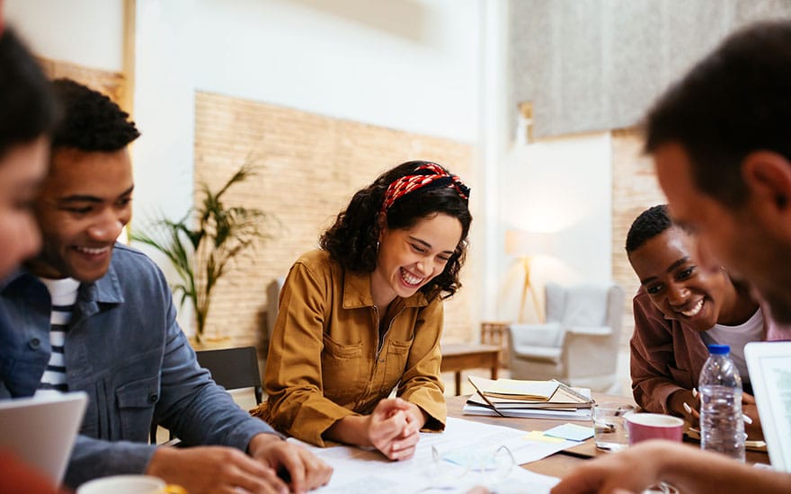 Successfull-woman-smiling-at-a-meeting-880-550