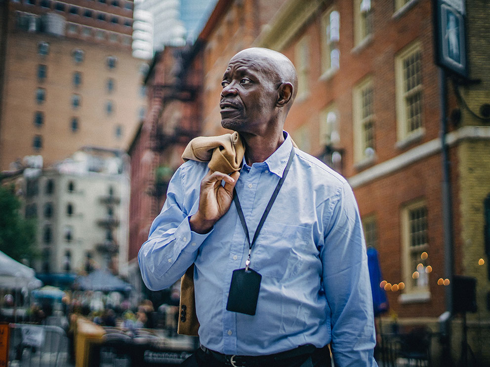 Respectable-black-businessman-standing-on-busy-street-992-744