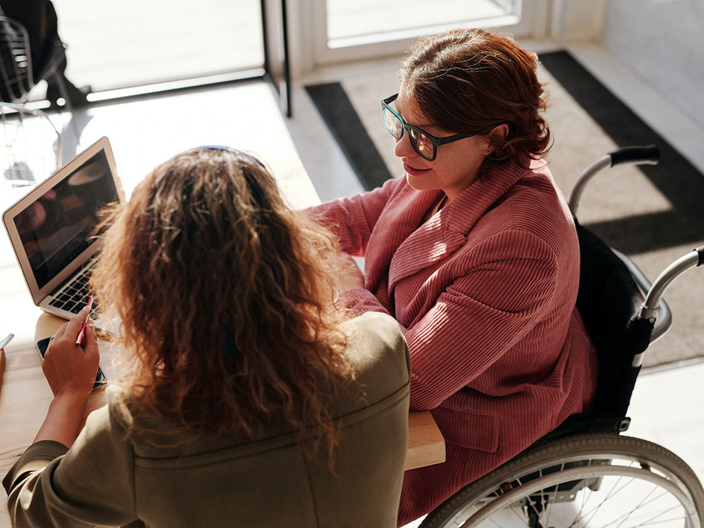 Woman-in-Red-Sweater-Wearing-Black-Framed-Eyeglasses-Sitting-on-Wheelchair