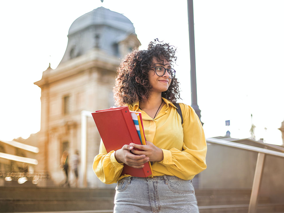 happy-young-girl-holding-books